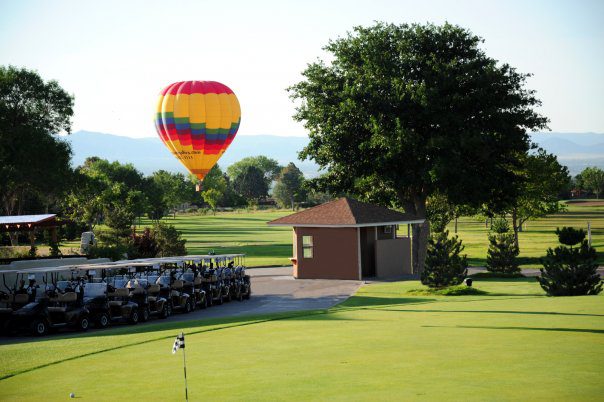 Colorful hot air balloon above golf course