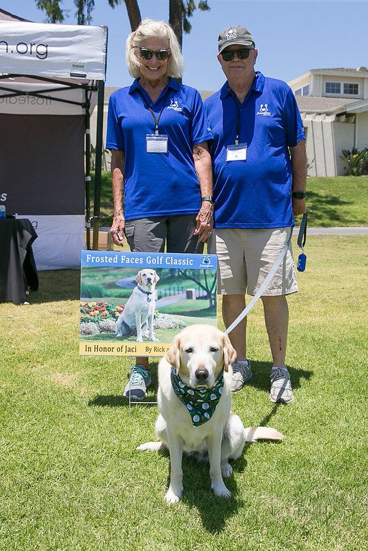 Couple with dog at golf fundraiser
